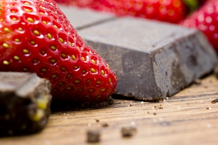 Strawberries  and raw chocolate on wooden tableの写真素材