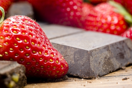 Strawberries  and raw chocolate on wooden tableの写真素材