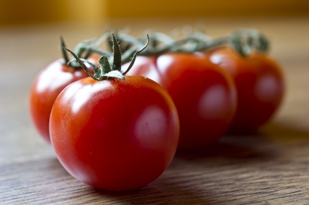 Ripe Fresh Cherry Tomatoes on wooden tableの写真素材