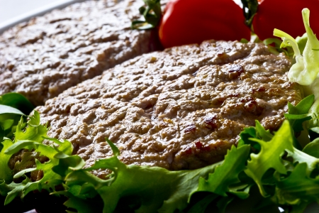 Juicy grilled hamburger with tomatoes, salad and green beansの写真素材