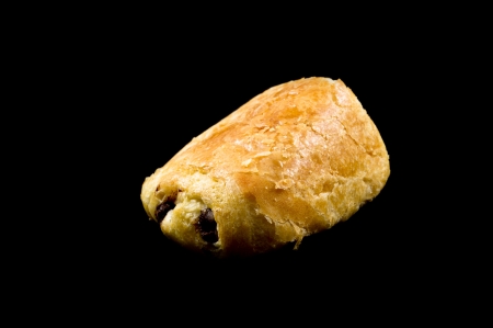 Fresh and tasty buns with raisins over black  backgroundの写真素材