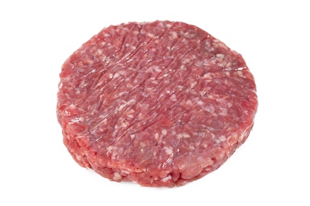 raw hamburger with protective film in white backgroundの写真素材