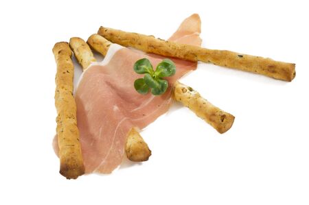 some italian grissini sticks with ham isolated on white backgroundの写真素材