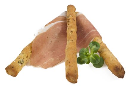 grissini sticks with ham isolated on white backgroundの写真素材