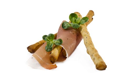 Italian prosciutto on a bread sticks isolated in white backgroundの写真素材