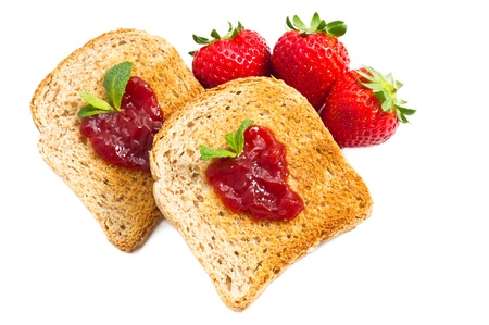 sweet strawberries jam on toast close up on white backgroundの写真素材