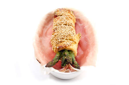 bunch of asparagus rolled with  puff pastry and speckの写真素材