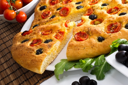 Apulian Focaccia with tomatoes and olivesの写真素材