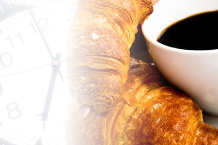 a cup of coffee with croissant on clock time backgroundの写真素材