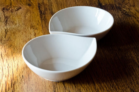 two white cups on wooden tableの写真素材