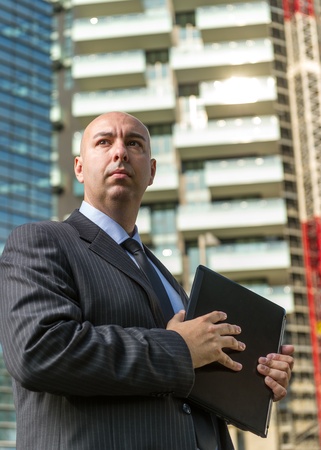 businessman in city background with notebook の写真素材