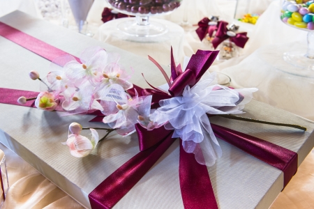 Wedding  or valentine gift with flowers over an elegant white tableの写真素材