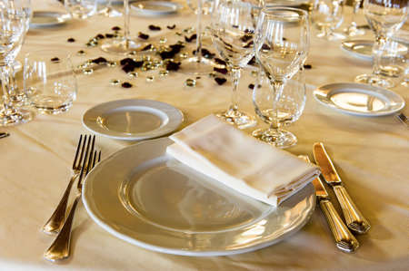 Fancy table set for a wedding dinner on evening lightの写真素材