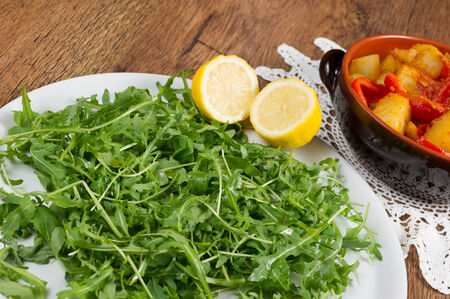 red peppers, potatoes and green salad called rucolaの写真素材