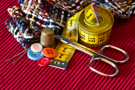 sewing kit accessories on red texture