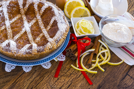 Typical sweet Campania - Neapolitan pastiera on wooden table with ingredientsの写真素材