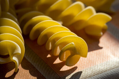 sun light drawing shadows with italian pasta called fusilliの写真素材