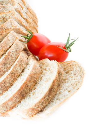sliced ??bread and red tomato on white backgroundの写真素材