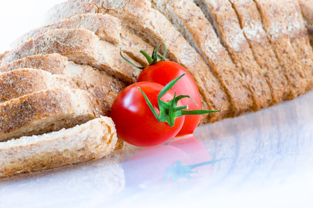 sliced ??bread and red tomato on white backgroundの写真素材