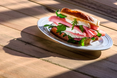 sandwich with ham and cheese in wooden tableの写真素材