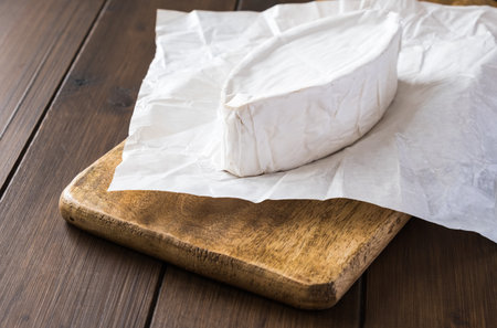 Brie cheese with white mold on the wooden background, close upの写真素材