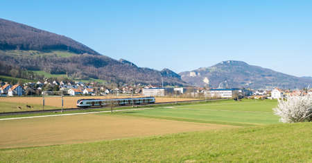 Swiss countryside landscape with a running train, Switzerland