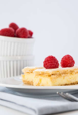 Vanilla custard slice with icing and fresh raspberries, close upの写真素材