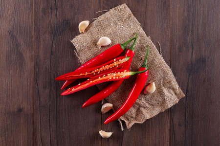 Red chili pepper with garlic top view on sackcloth