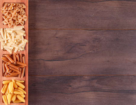 Top view pasta in wooden plate with copy spaceの写真素材
