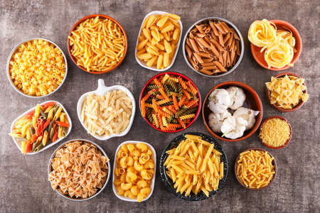 Various raw pasta types plates, top viewの写真素材