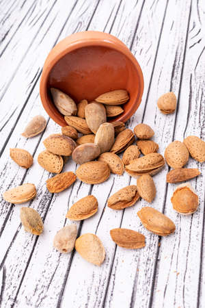 Almonds spreaded on the wooden backgroundの写真素材