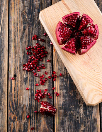 Top view pomegranate on wooden cutting board on tableの写真素材