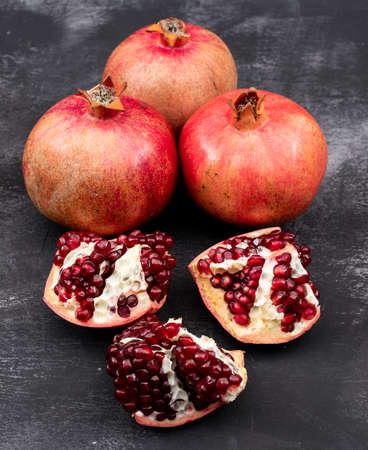 Fresh pomegranates on dark tableの写真素材