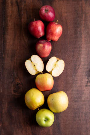 Top view apples on brown wooden background verticalの写真素材