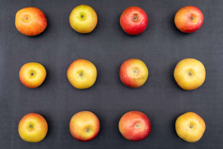 Top view apples pattern on black wooden background horizontalの写真素材