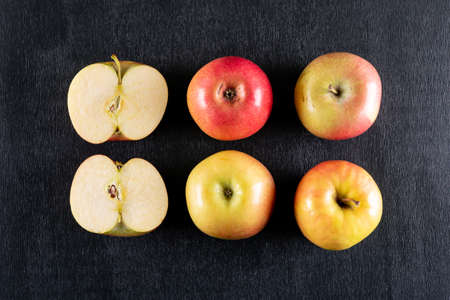 Top view apples sliced on black wooden background horizontal