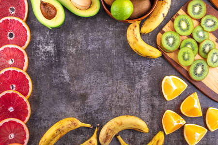 Citrus fruits frame, top view with copy space on dark backgroundの写真素材