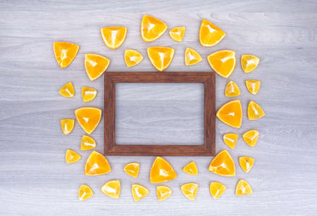 Photo frame surrounded by orange slicesÐ± top view with copy space