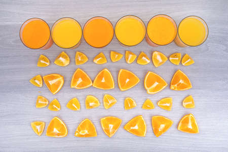 Orange juice with orange slices, top view on white wooden table