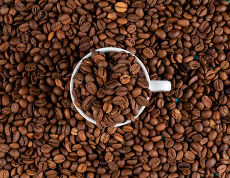 Top view coffee beans with cup texture background