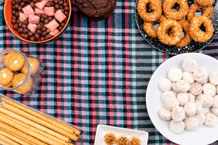 Top view different cookies on cloth background