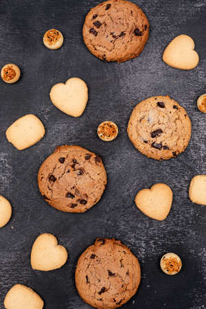 Top view different cookies on dark background
