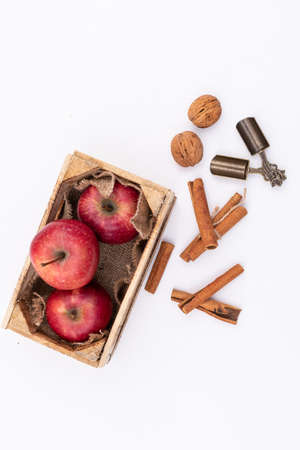 Red apples in wooden box on white backgroundの写真素材