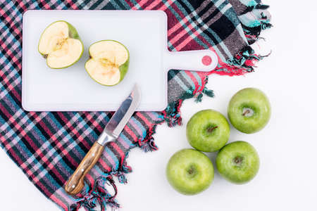 Top view green apples on colored cloth on white background