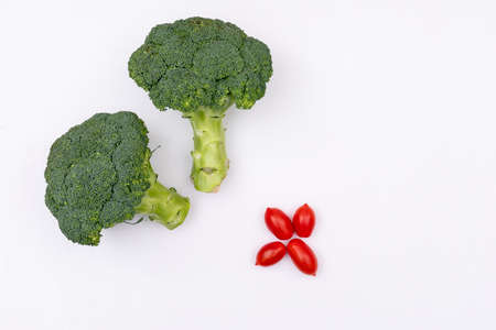Top view broccoli and cherry tomatoes on white backgroundの写真素材