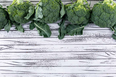 Top view broccoli with copy space on white wood table
