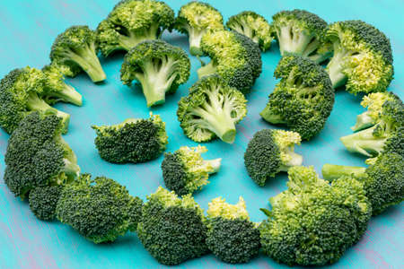 Bunch of fresh broccoli on blue backgroundの写真素材