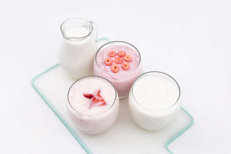 Side view of yogurt and milk on white background horizontal