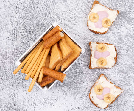 Top view of crackers and toasts on white background horizontalの写真素材