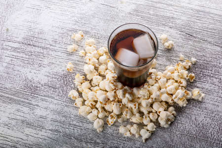 Side view of popcorn and lemonade on white background horizontal